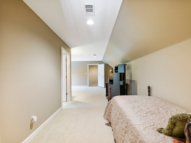 bedroom featuring vaulted ceiling and light colored carpet