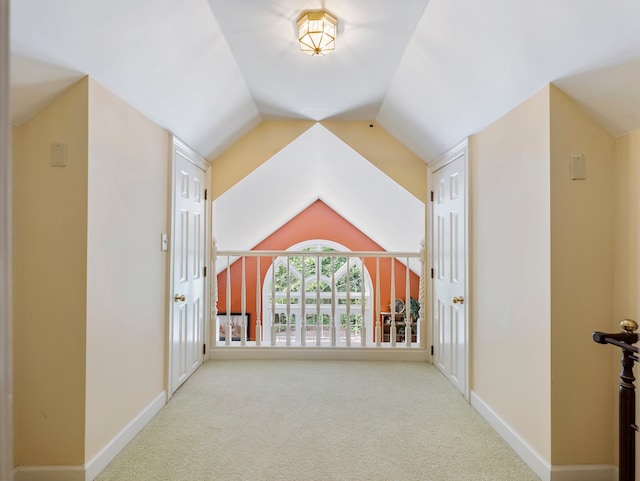 corridor featuring carpet floors and lofted ceiling