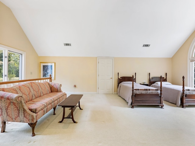 bedroom featuring light carpet and vaulted ceiling