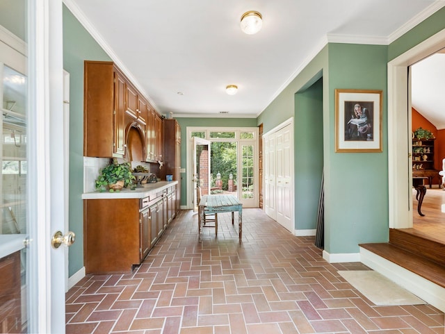 4394 Holly Springs Rd, Pendergrass, GA 30567 - kitchen with light countertops, brown cabinetry, brick floor, and baseboards