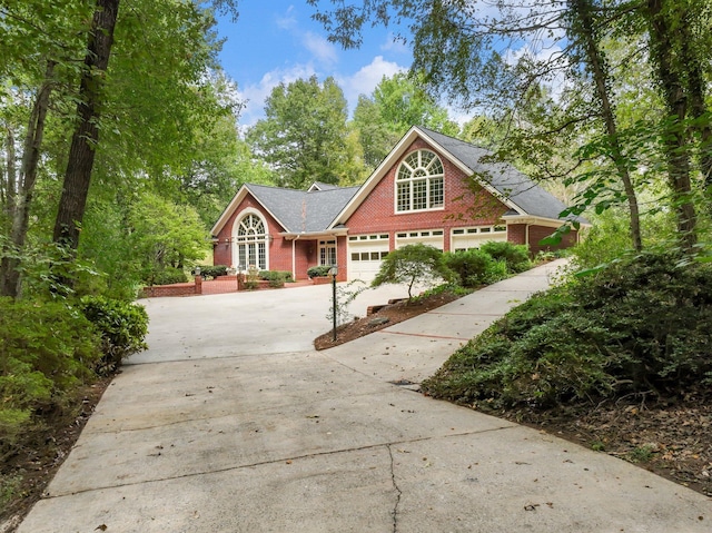 4394 Holly Springs Rd, Pendergrass, GA 30567 - view of front of property featuring brick siding, driveway, and a garage