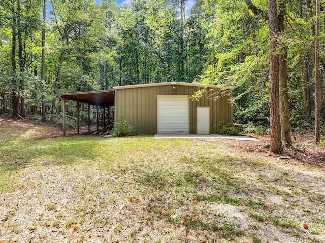 4394 Holly Springs Rd, Pendergrass, GA 30567 - exterior space with an outbuilding, a garage, and a forest view