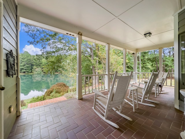 unfurnished sunroom with a water view