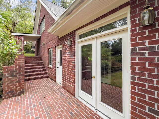 entrance to property featuring french doors and a patio area