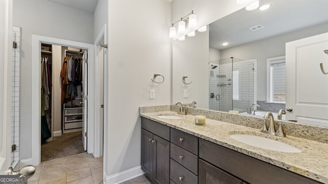 bathroom featuring walk in shower, vanity, and tile patterned floors