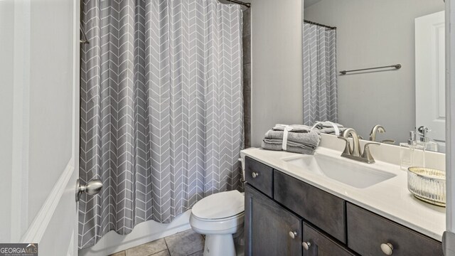 full bathroom featuring vanity, shower / tub combo with curtain, toilet, and tile patterned floors