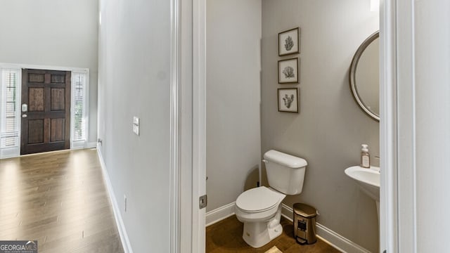 bathroom with wood-type flooring and toilet