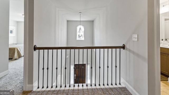 stairway featuring carpet