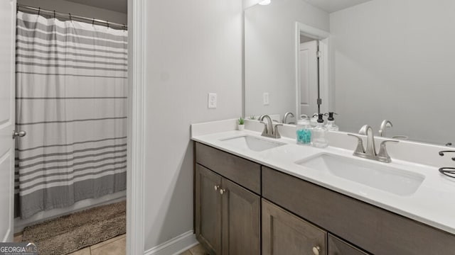 bathroom with walk in shower, vanity, and tile patterned flooring