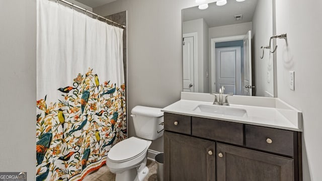 bathroom featuring vanity, toilet, and tile patterned floors