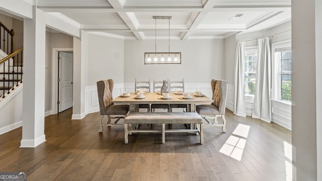 dining area with crown molding, coffered ceiling, dark hardwood / wood-style flooring, and beamed ceiling