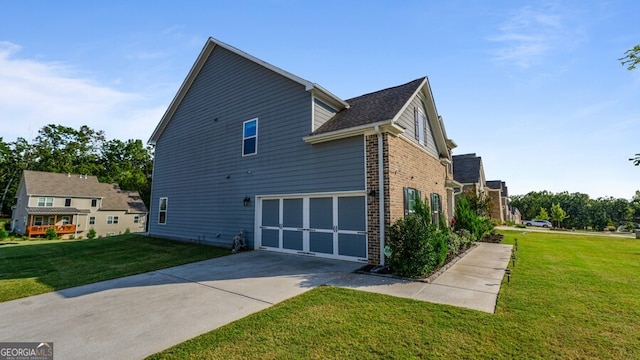 exterior space with a yard and a garage