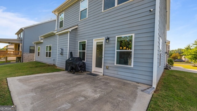 rear view of property featuring a patio area and a yard