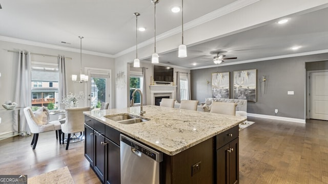 kitchen featuring pendant lighting, dishwasher, dark wood-type flooring, sink, and an island with sink