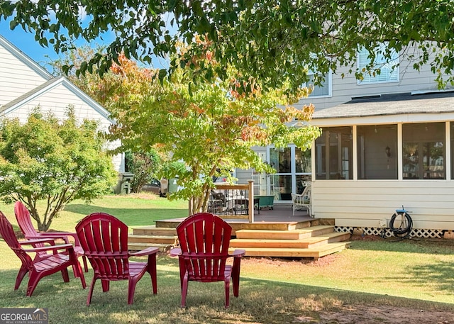 view of yard featuring a deck and a sunroom