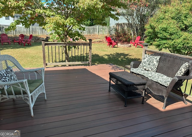 deck with a lawn and an outdoor fire pit