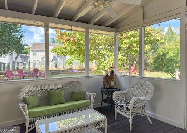 sunroom / solarium with vaulted ceiling, ceiling fan, and a wealth of natural light