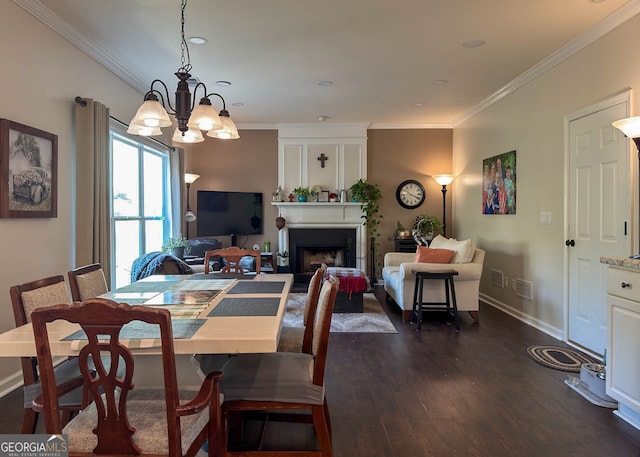 dining area with ornamental molding, a chandelier, and dark wood-type flooring