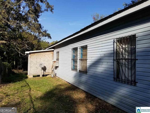 view of side of home featuring a yard