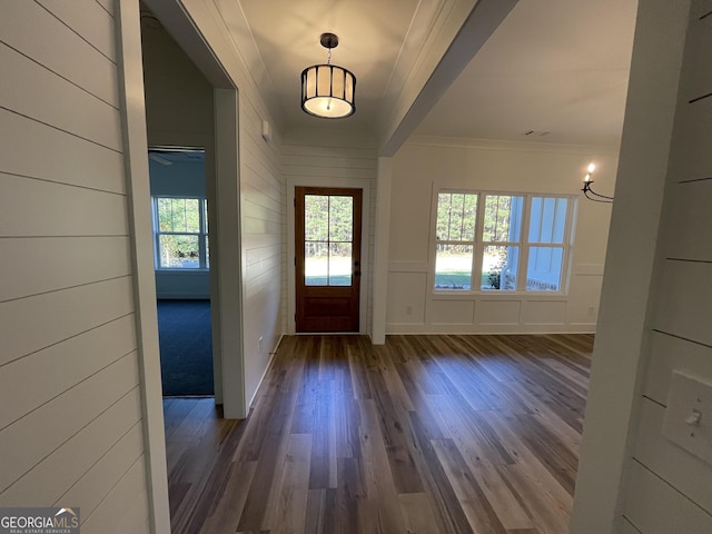 entryway featuring crown molding and dark wood-type flooring