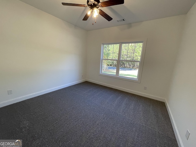 unfurnished room featuring ceiling fan and dark carpet