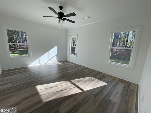 unfurnished room with ornamental molding, dark hardwood / wood-style flooring, and plenty of natural light