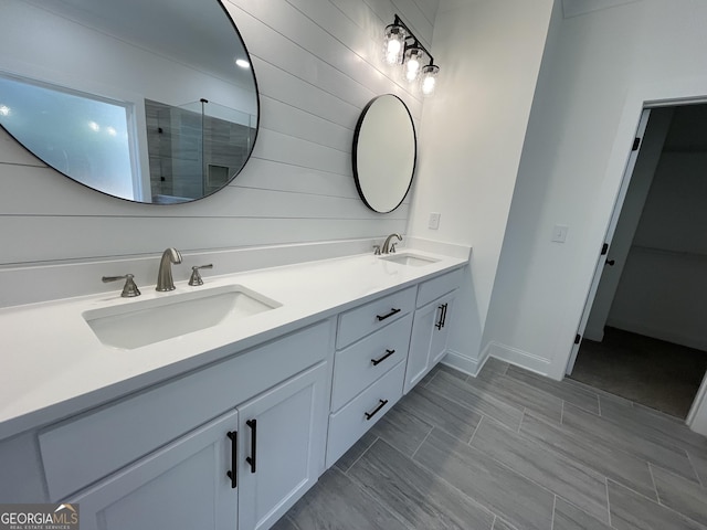 bathroom with vanity and a shower with door