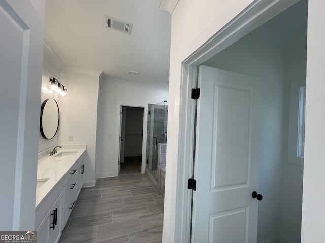 bathroom featuring walk in shower, ornamental molding, and vanity