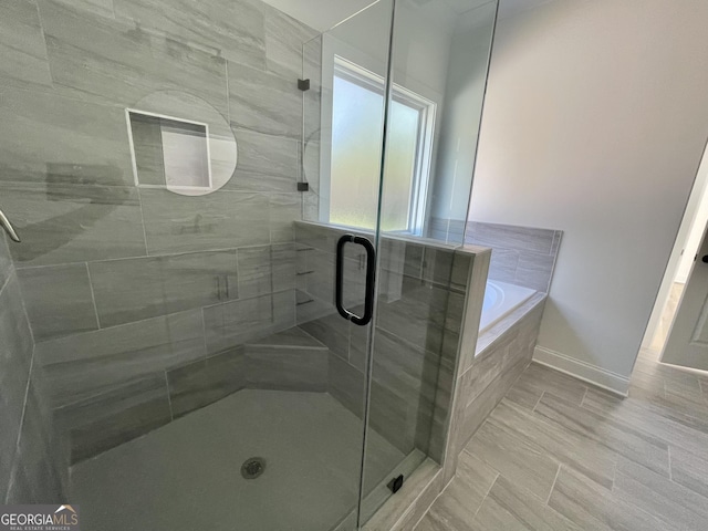 bathroom featuring plus walk in shower