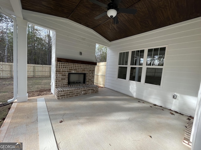 view of patio featuring an outdoor brick fireplace and ceiling fan