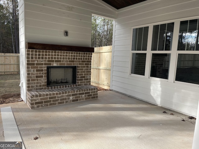 view of patio featuring an outdoor brick fireplace