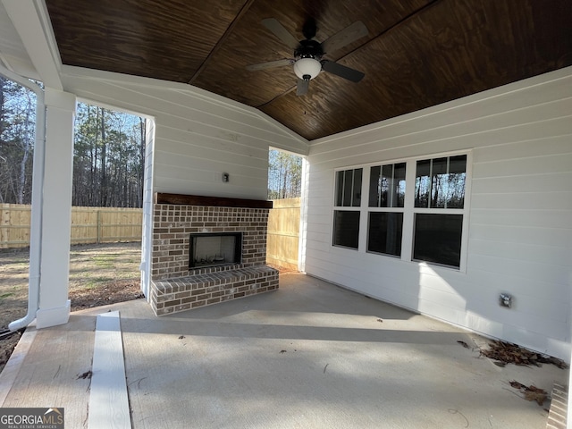 view of patio with an outdoor brick fireplace and ceiling fan