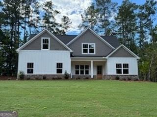 rear view of house featuring a yard