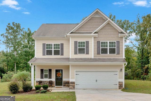 craftsman house featuring a front yard, a garage, and a porch