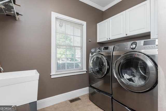 laundry area with cabinets, sink, separate washer and dryer, ornamental molding, and light tile patterned flooring