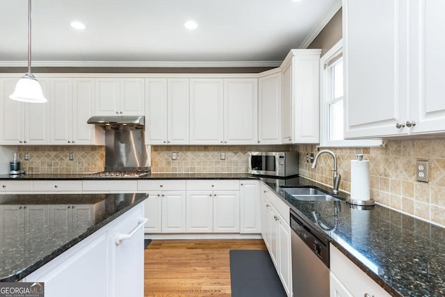 kitchen featuring white cabinetry, sink, hanging light fixtures, dark stone counters, and appliances with stainless steel finishes