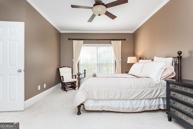 carpeted bedroom with ceiling fan and crown molding