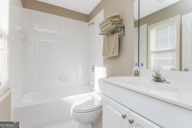 full bathroom with tiled shower / bath, vanity, and toilet