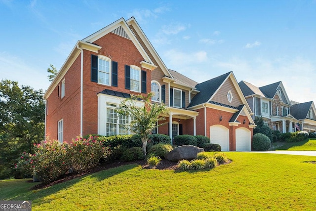 view of front facade with a front yard and a garage