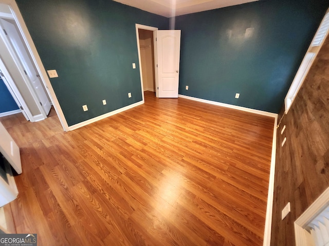 spare room featuring hardwood / wood-style flooring