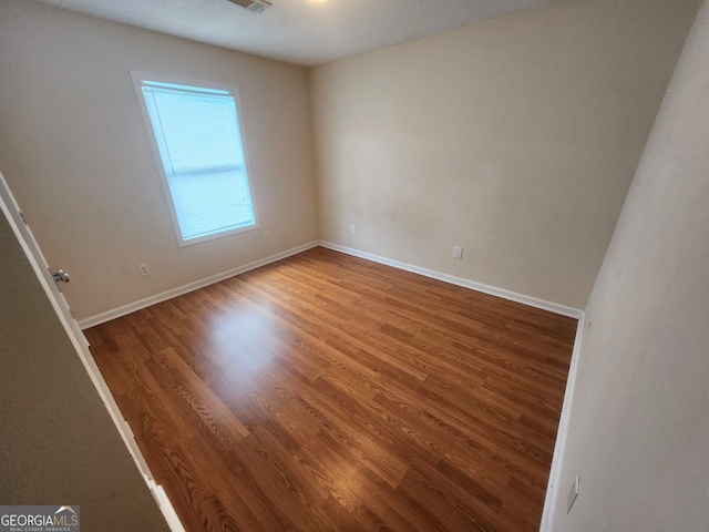 bathroom with hardwood / wood-style floors, vanity, and toilet