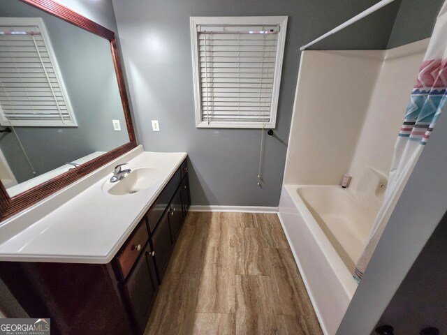 spare room with visible vents, baseboards, and wood finished floors