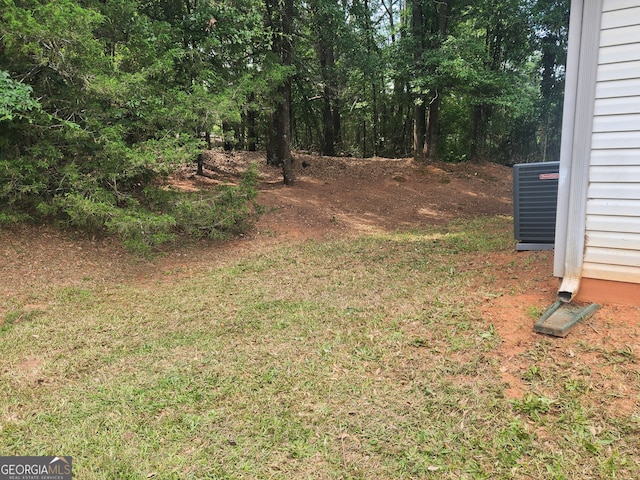 view of yard featuring central air condition unit