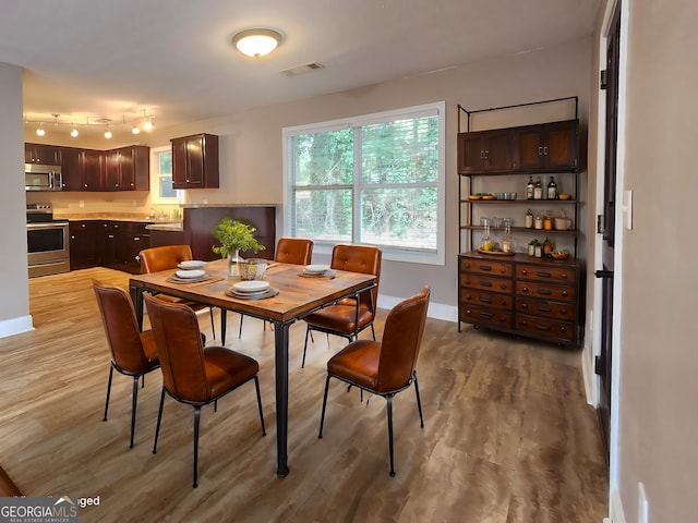 spare room with dark hardwood / wood-style floors, a healthy amount of sunlight, and vaulted ceiling