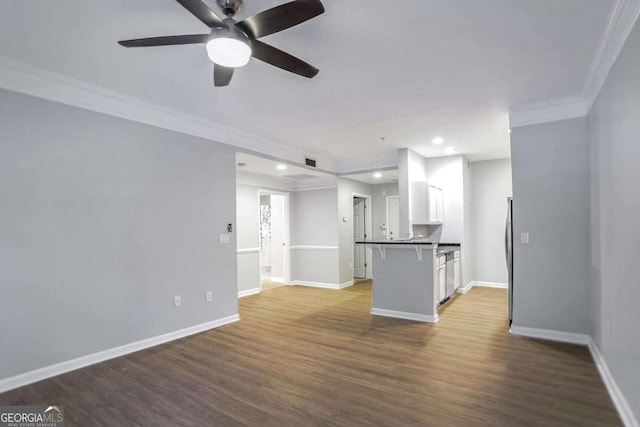 unfurnished living room with crown molding, hardwood / wood-style floors, and ceiling fan