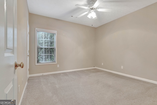 unfurnished room featuring ceiling fan and carpet flooring