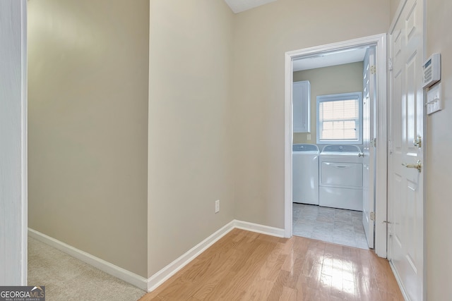 hall featuring light hardwood / wood-style floors and independent washer and dryer