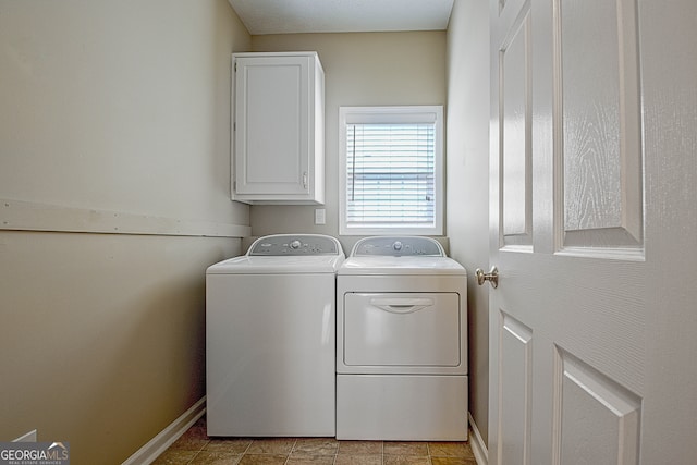 laundry room featuring independent washer and dryer and cabinets