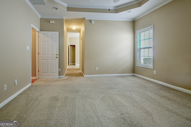 empty room with ornamental molding and light colored carpet