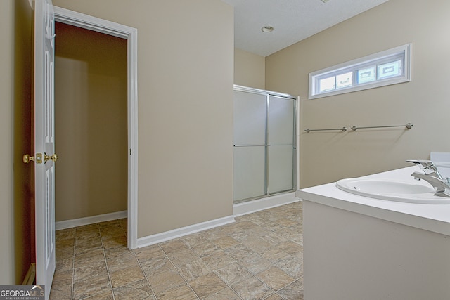 bathroom with vanity and a shower with shower door